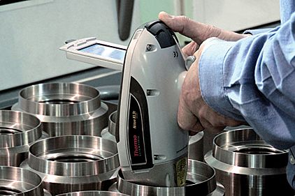 Handheld XRF analyzer verifying the alloy of machined metal parts