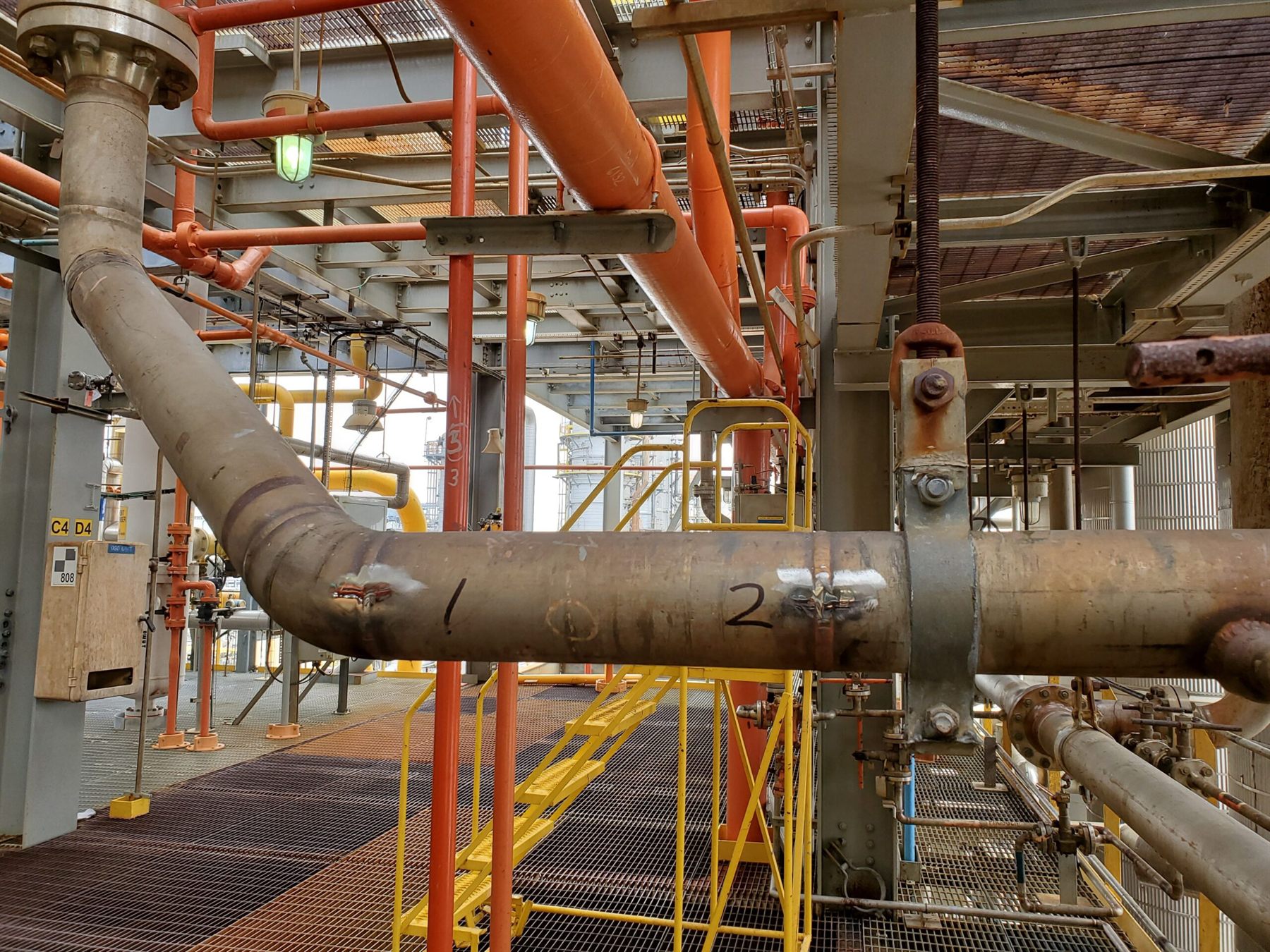 Process piping with weld locations marked for positive material identification